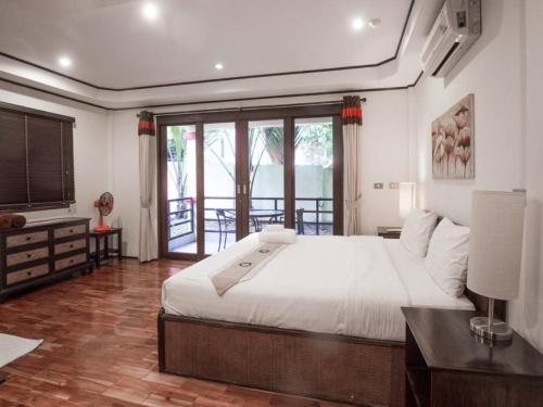 a bedroom with a large white bed and a balcony at 3 Bedroom Seaview Island View Koh Phangan SDV233-By Samui Dream Villas in Srithanu