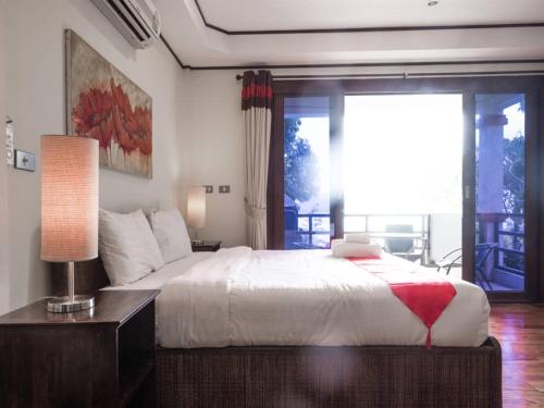 a bedroom with a large bed and a large window at 3 Bedroom Seaview Island View Koh Phangan SDV233-By Samui Dream Villas in Srithanu