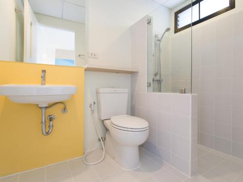 a bathroom with a toilet and a sink at Hop Inn Phitsanulok in Phitsanulok