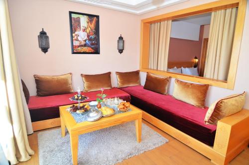 a living room with a couch and a mirror at Atlantic Palm Beach in Agadir