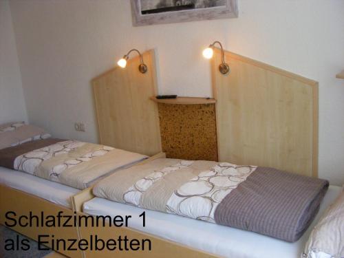 two beds in a small room with twoermottermott at Ferienwohnung Huber in Dornbirn