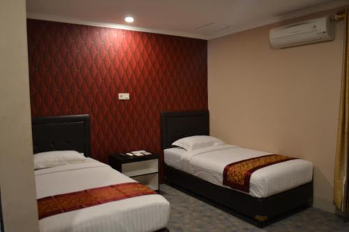 Кровать или кровати в номере Puncak Budget Hotel