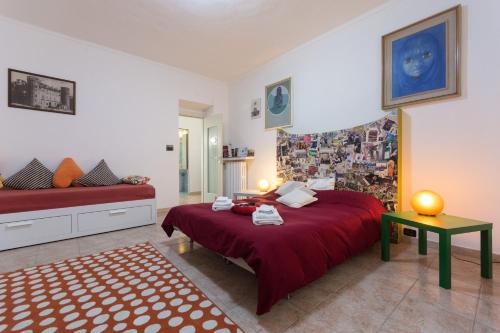 a bedroom with a red bed and a table at Apartment Silvia in Turin