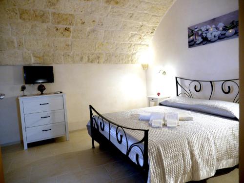 Un pat sau paturi într-o cameră la Le Arcate