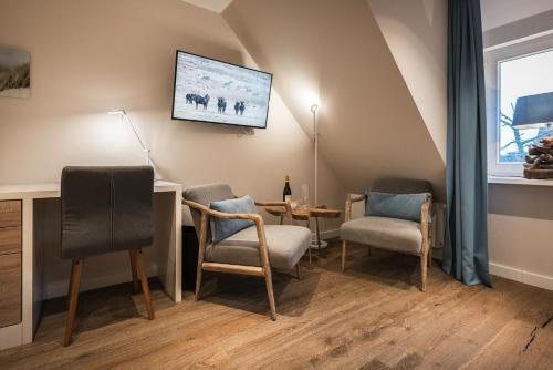 TV a/nebo společenská místnost v ubytování Landhaus Sylter Hahn