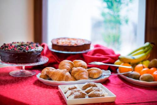 a table topped with cakes and pastries and desserts at Hotel Centrale Spa & Relax in Alcamo