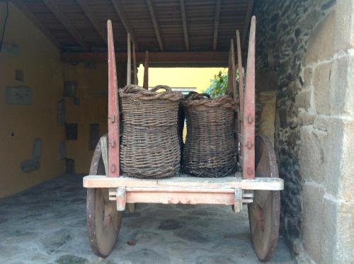 a cart with two baskets on the back of it at Curral de l Tiu Pino in Sendim