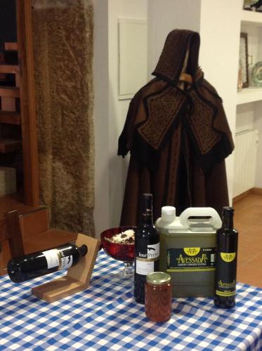 a table topped with a bottle of wine and a bottle of wine at Curral de l Tiu Pino in Sendim