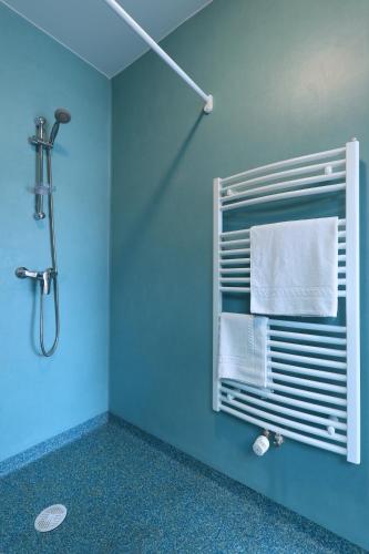 La salle de bains est pourvue de murs bleus et d'un porte-serviettes. dans l'établissement Apparteo Bordeaux, à Bordeaux