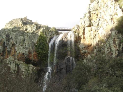 a waterfall on the side of a mountain at Curral de l Tiu Pino in Sendim