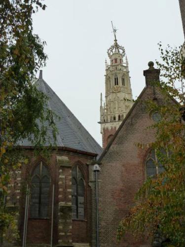 a church with a clock tower on top of it at Bed & Breakfast Frans Hals Haarlem in Haarlem