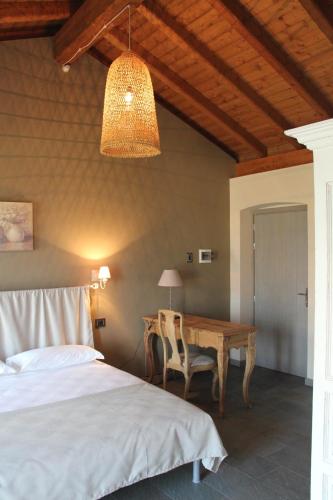 a bedroom with a bed and a wooden table at Agriturismo Treterre in Pianello Del Lario