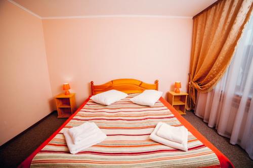 En eller flere senge i et værelse på Pansionat Slavskiy