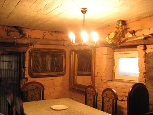 a dining room with a table and chairs and a window at Vilni Kimnaty in Mukacheve