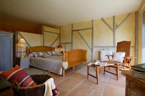 a bedroom with a bed and a table and chairs at Château de Termes in Martel