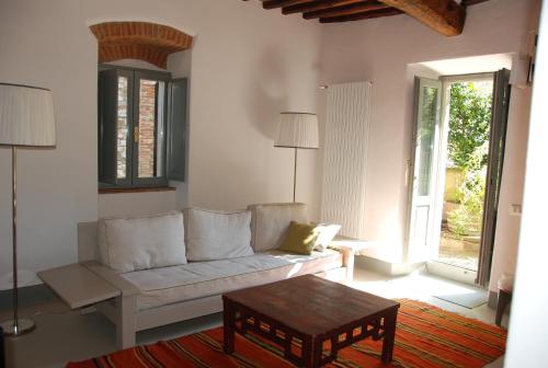 a living room with a couch and a coffee table at Garden Apartment in Greve in Chianti