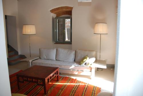 a living room with a couch and a table at Garden Apartment in Greve in Chianti