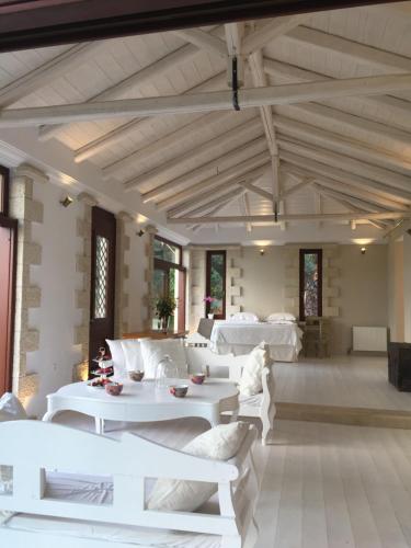 a living room with white couches and tables at Icons Sea of Crete in Malia