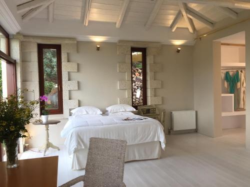 a bedroom with a large white bed and a table at Icons Sea of Crete in Malia
