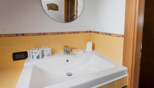 a bathroom with a white sink and a mirror at Italianway-Panfilo Castaldi 17 in Milan