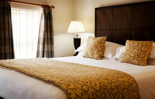 a bedroom with a large bed and a window at Trout Hotel in Cockermouth