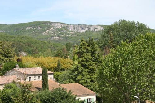 a mountain in the distance with houses and trees at Logis Hôtel Le Jabron in La Bégude-de-Mazenc