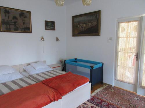 a bedroom with a bed with a red blanket at Sissi Residence with free parking lot in Budapest
