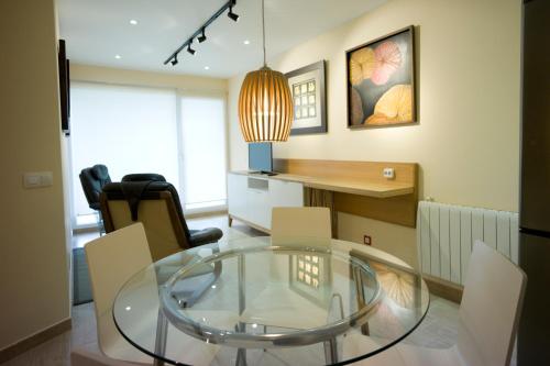 sala de estar con mesa de cristal y sillas en Apartamento Premium Playa Altar 2, en Barreiros