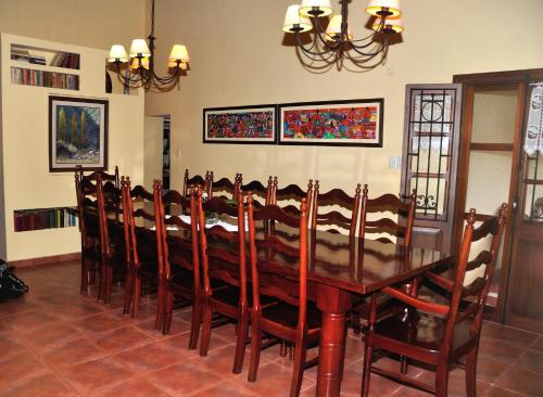 a dining room with a wooden table and chairs at Finca Cielo Verde in Chicoana