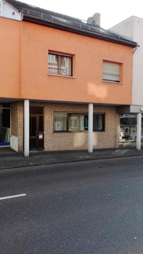 an orange building on the side of a street at Pension Haus Baron 4 Mühlheim in Mühlheim