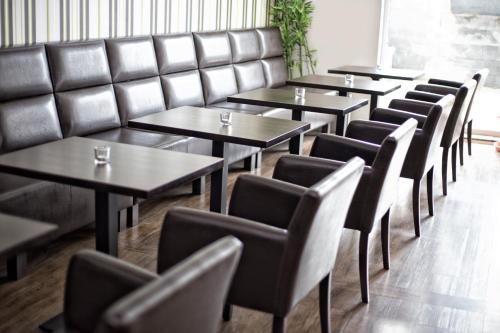 a row of tables and chairs in a restaurant at Hotel Slavie in Cheb