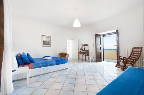 a bedroom with a bed and a view of the ocean at Appartamento Cassano Blu in Piano di Sorrento