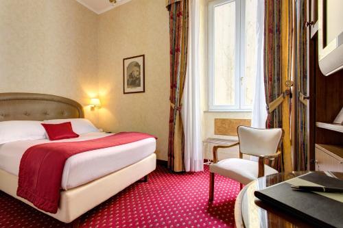 a hotel room with a bed and a chair at Hotel Nazionale in Rome