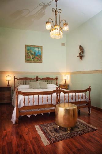 a bedroom with a large bed and a large metal tub at Guest House a Portapalermo in Santo Stefano di Camastra