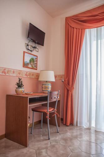 a room with a desk with a computer and a window at Guest House a Portapalermo in Santo Stefano di Camastra