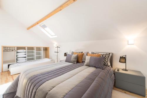 a bedroom with a large bed in a white room at LovelyStay-Modern Loft City Center in Porto