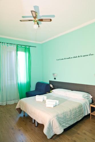 a bedroom with a bed and a ceiling fan at Le Stanze di Boccadasse in Genova
