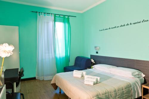 a blue bedroom with a bed with towels on it at Le Stanze di Boccadasse in Genova