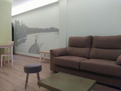 a living room with a couch and a table at Alojamientos Dezerto Bardenas in Arguedas