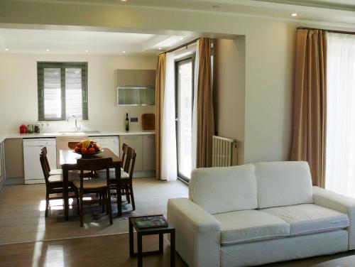 a living room with a white couch and a table at Gocek Riviera Apart in Göcek