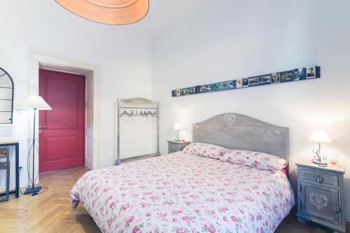 a bedroom with a bed and a red door at Bolzano Rooms in Bolzano