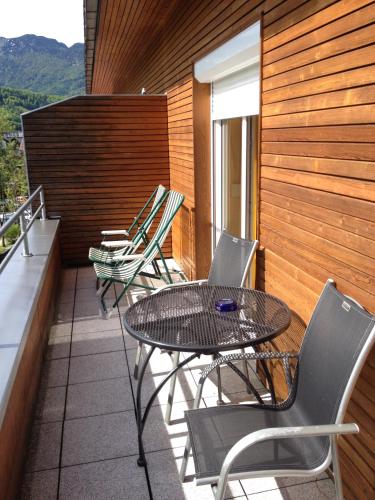 a patio with a table and chairs on a balcony at Wohlfühlhotel Goiserer Mühle in Bad Goisern