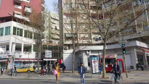 a group of people walking on a city street at Hotel Austria in Tirana