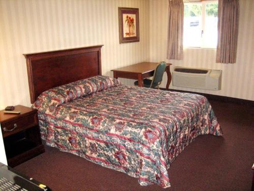 a hotel room with a bed and a desk at Fair Motel in Upper Saddle River