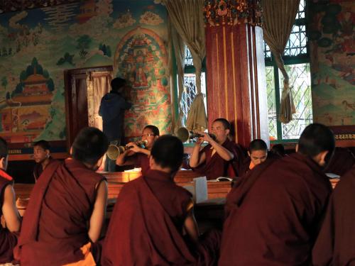 a group of monks in a buddhist temple at The Pavilions Himalayas The Farm in Pokhara