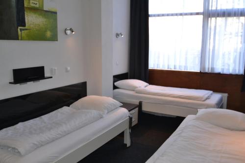 Postel nebo postele na pokoji v ubytování Hotel Bienvenue
