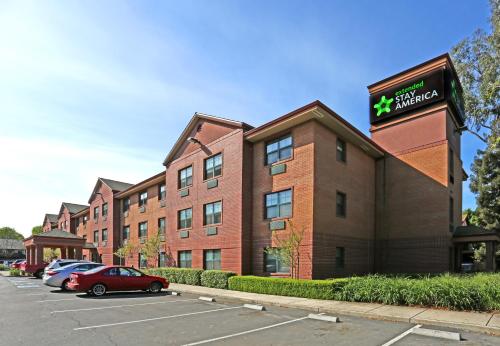 a hotel with cars parked in a parking lot at Extended Stay America Suites - Stockton - March Lane in Stockton