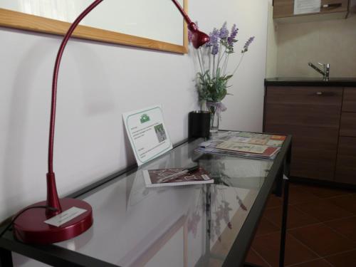 a red lamp sitting on top of a glass table at B&B LA Garzetta in Adria