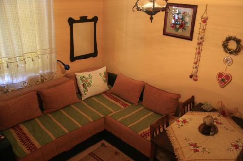 a living room with a couch and a table at Base for Adventurers - Urban Guerrilla in Negotin