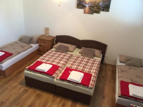 a bedroom with two beds and a wooden floor at Privat Pani Danka in Dolný Kubín